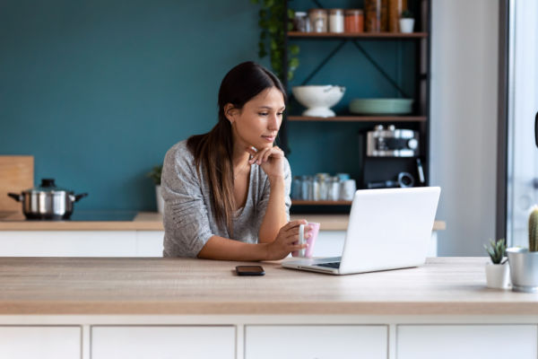 A young woman contacts a law firm on her laptop