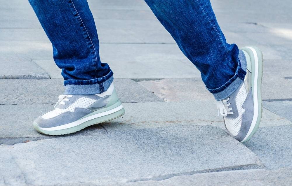 someone in trainers tripping on uneven paving stones A Guide to the Personal Injury Claims Process – A Trip on Paving Stones someone in trainers tripping on uneven paving stones