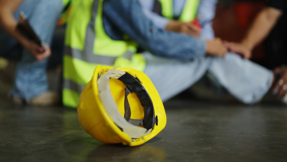 Work helmet with injured worker.