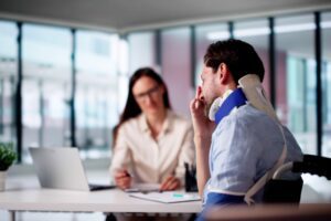 a man who has suffered a serious injury to his neck speaking to a lawyer